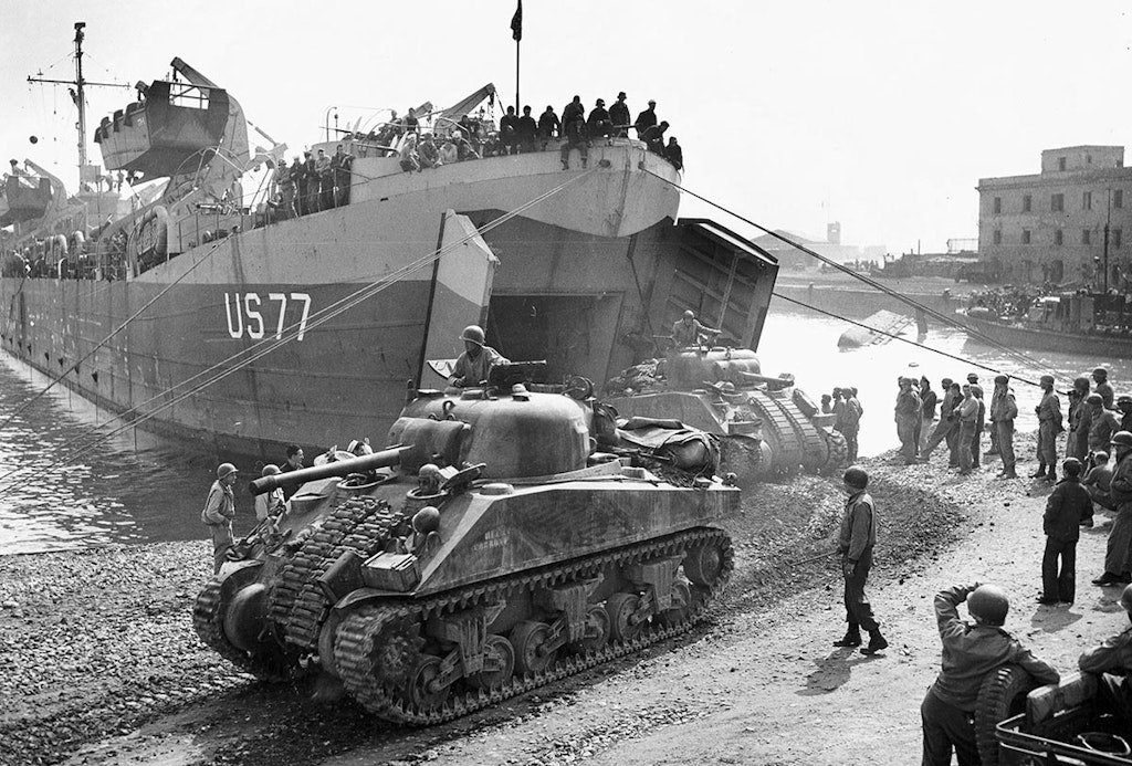 sherman tanks unloading from a boat